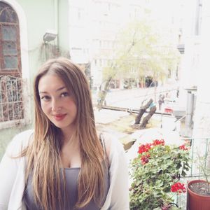 Portrait of smiling young woman against flowers