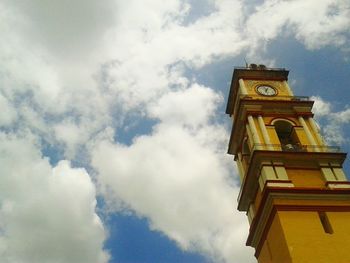 Low angle view of building against cloudy sky