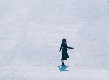 Full length side view of woman walking in city