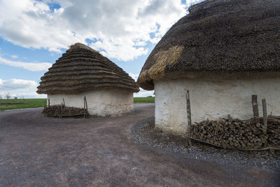 Panoramic shot of building on field against sky