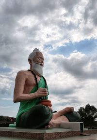 Low angle view of statue against sky