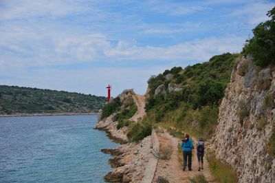 Two senior women walking along the sea shore