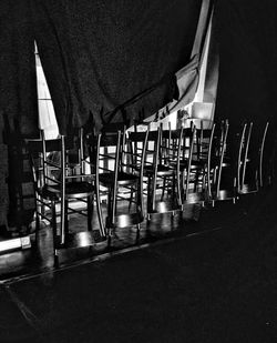 View of empty chairs and tables at night