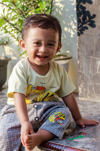 Portrait of cute boy sitting at home