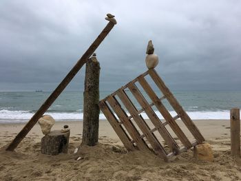 Low angle view of seagulls on beach against sky