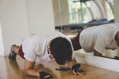 People relaxing on hardwood floor at home