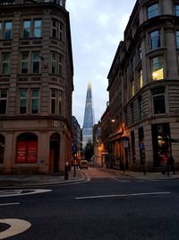 City street and buildings against sky