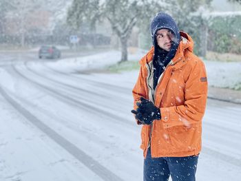 Man wearing hat standing in snow