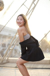 Portrait of young woman sitting on floor