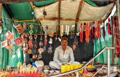 Vendor with decors for sale at market stall