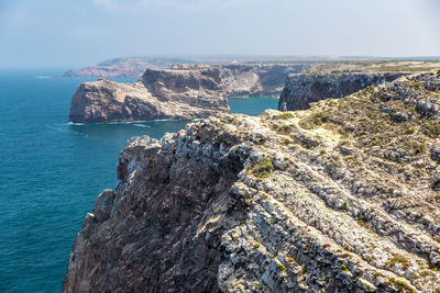 Scenic view of sea and rocks against sky