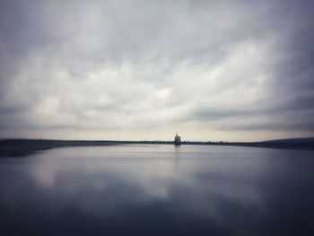 Scenic view of sea against cloudy sky