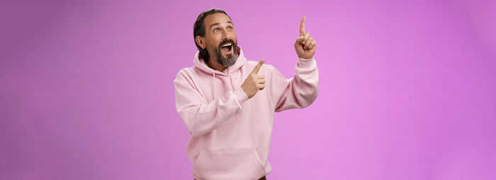 Portrait of woman standing against blue background