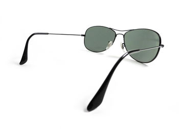 Close-up of sunglasses on table against white background