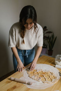 Young woman making christmas cookies