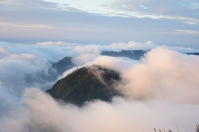 Low angle view of clouds over mountains