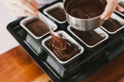 High angle view of person holding ice cream on table