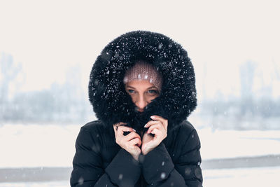 Portrait of young woman wearing hat during winter