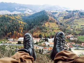 Low section of man relaxing on mountain
