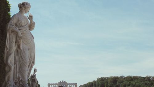 High angle view of elegant statue against cloudy sky