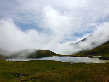 Scenic view of waterfall against sky