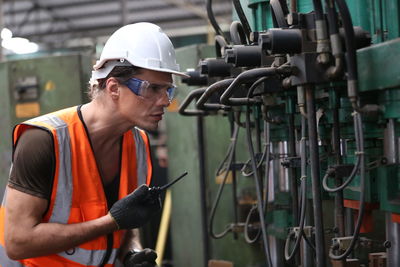 Rear view of man working in factory