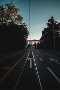 Empty road along buildings