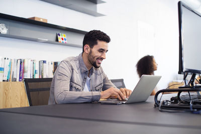 Colleagues working at desk in office