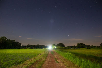 Scenic view of field against sky at night