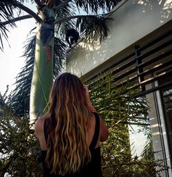 Woman standing on tree trunk