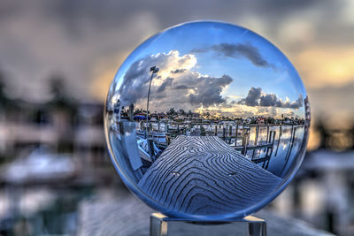 Crystal ball of boats docked at a marina near venetian bay in naples, florida at sunrise.