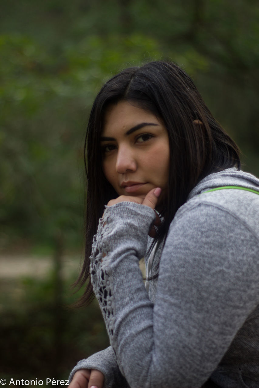 PORTRAIT OF YOUNG WOMAN LOOKING DOWN