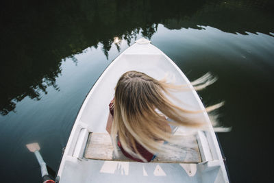 Rear view of woman on boat in lake