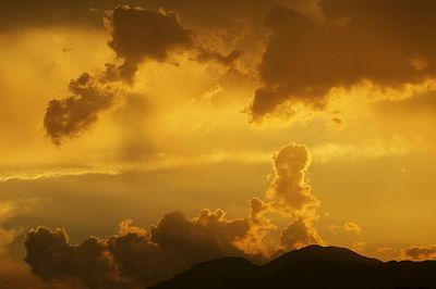 Scenic view of dramatic sky at sunset