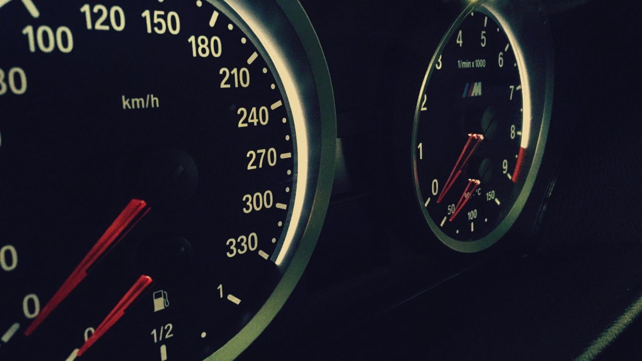 transportation, mode of transport, land vehicle, car, text, vehicle interior, communication, travel, western script, car interior, number, indoors, close-up, speed, speedometer, dashboard, night, road, part of, on the move