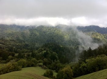 Scenic view of mountains against cloudy sky