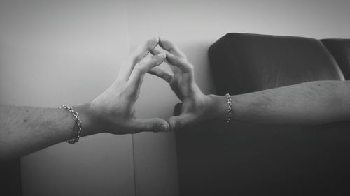 Cropped hand of man reflecting on mirror