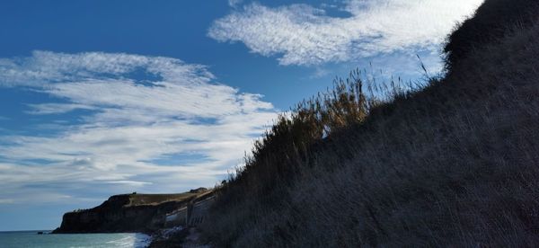 Low angle view of sea against sky during winter