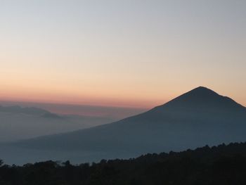 Scenic view of silhouette mountains against sky during sunset