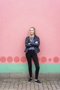 Young beautiful woman in front of colorful wall enjoying outdoors