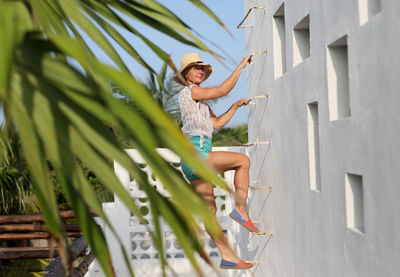 Portrait of young woman on ladder
