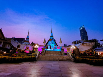 Illuminated building against blue sky at dusk
