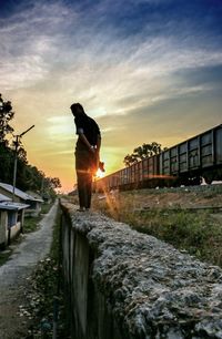 People walking on road at sunset