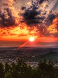 Scenic view of landscape against orange sky