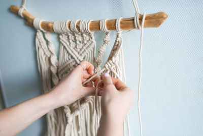 Cropped hand of woman holding rope