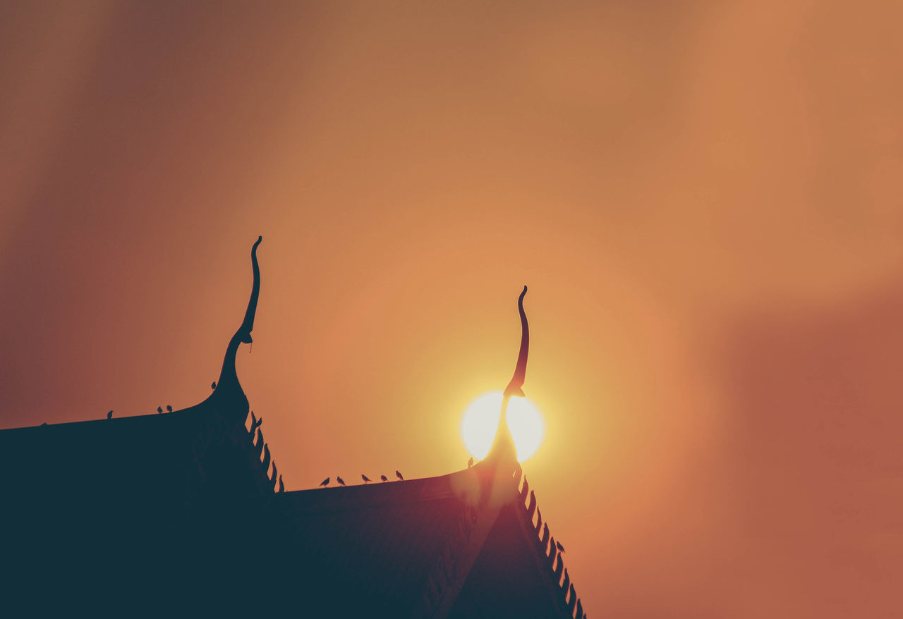 LOW ANGLE VIEW OF SILHOUETTE ROOF AGAINST BUILDING DURING SUNSET