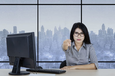 Portrait of businesswoman pointing in office