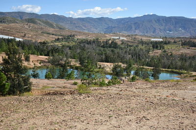 Scenic view of lake and mountains against sky