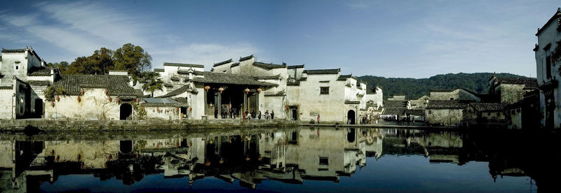 Reflection of buildings in water against sky