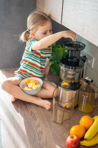 High angle view of cute girl preparing food on table